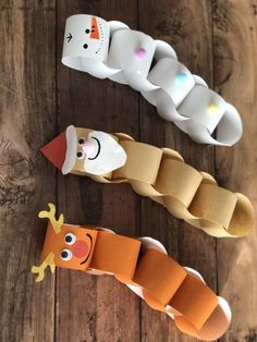 three different types of toothbrush holders sitting on top of a wooden table