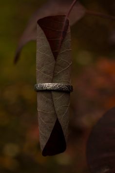 I love the design of this ring, I call it my feathery fern ring because that's what it looks like to me. The textured wraps around the entire band, and the inside of the band is rounded making it incredibly comfortable to wear. See last picture. This is a good size handcrafted sterling silver band (3.5 mm wide) with a nice weight to it. It looks great alone, or paired with other stacking rings. I've been wearing mine stacked with my triple moon ring nonstop for the last few months and it's the m Nature-inspired Adjustable Stackable Rings For Promise, Bohemian Stackable Adjustable Rings For Anniversary, Bohemian Adjustable Stackable Rings For Anniversary, Bohemian Engraved Promise Ring, Fern Ring, Pretty Wedding Rings, Feather Ring Silver, Botanical Ring, Feather Ring