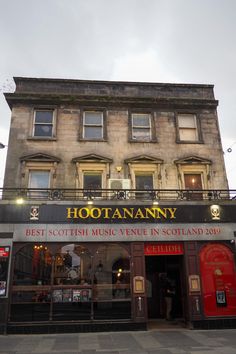 an old building with many windows and signs on the front