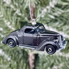 an old black car ornament hanging from a christmas tree