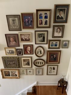 a staircase with many framed pictures on the wall