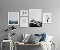 an image of a living room with pictures on the wall and photos hanging above it