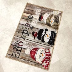 two snowmen on a wooden sign with the words happy holidays written below them, sitting on a tile floor