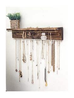 a wooden shelf with many necklaces hanging from it