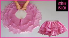 a pink skirt with ruffles on it next to a woman's hand