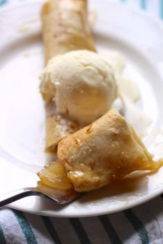 two dessert items on a plate with a fork