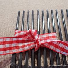 a red and white checkered ribbon tied to a fork