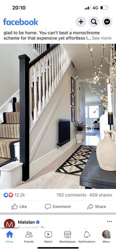 an image of a house with stairs and pictures on the front door, above which is a black and white area rug