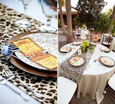 the table is set with leopard print plates and place settings for an elegant dinner party