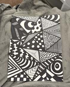 a black and white drawing on top of a gray blanket