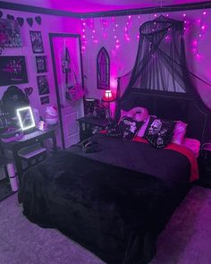 a bedroom decorated in purple and black with pink lights on the ceiling, bedding and decorations