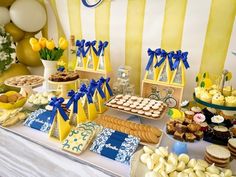 a table topped with lots of desserts and pastries