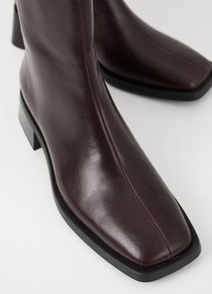 Blanca is the contemporary ankle boots with a minimal design. The style is crafted in dark brown leather featuring square toes, inside zippers and detailed seams along the upper. The thin outsoles sets on 47mm flared heels. Dark brown leather Square toes 47mm flared heels Inside zippers For long-lasting care: use neutral shoe cream and protector spray to ensure a longer lifespan for your shoes. Shaft height: 189 mm Shaft width: 253 mm Heel height: 47 mm (based on size 37) Article no.: 5217-201-35 Vagabond Shoes, Clogs Heels, Neutral Shoes, Style Goals, Chocolate Leather, Cream Shoes, Square Toe Boots, Toe Boots, Goat Leather