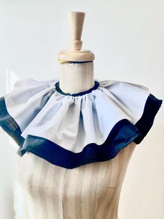 a mannequin wearing a blue and white dress with ruffles on it