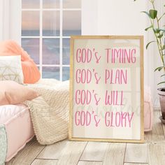 a pink and white sign sitting on top of a wooden floor next to a window