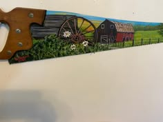 a painting on the side of a wall with a knife and farm scene painted on it