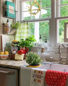 a kitchen sink sitting under a window next to a dishwasher and a stove top oven