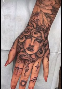 a woman's hand with tattoos on it