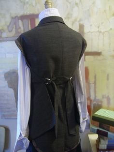 the back of a man's black vest on display