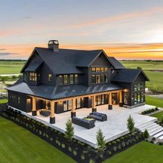 an aerial view of a large house at sunset