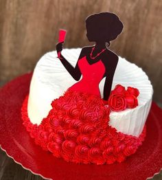 a red and white cake with a woman holding a wine glass in it's hand