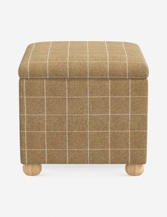 the footstool is made out of fabric and wooden legs, with a checkered pattern