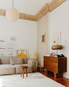 a living room filled with furniture and a white rug