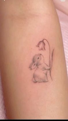 a small bunny tattoo on the thigh