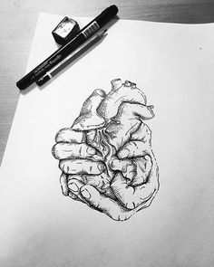 a drawing of a hand holding a heart on top of a piece of paper next to a marker