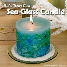 a candle that is sitting on top of a table with sea glass candles in front of it