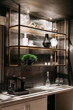 a kitchen counter topped with lots of glass shelves