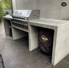 an outdoor bbq grill is built into the side of a building with a bag in it