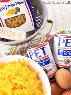 eggs, cheese and other ingredients are sitting on a counter next to cans of butter