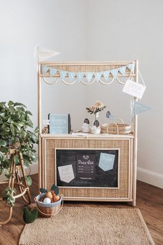 an ice cream stand is set up on the floor next to a potted plant