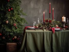 a christmas table setting with candles and decorations