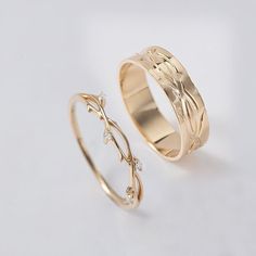 two gold wedding rings on a white background