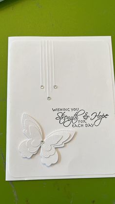 a white card with a butterfly on it and the words, wishing you strength for hope