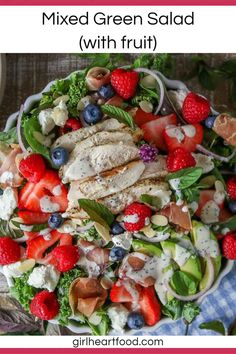 a salad with chicken, strawberries and blueberries in it