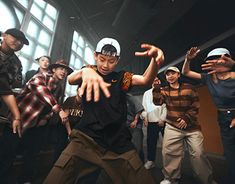 a group of young men standing next to each other on top of a dance floor