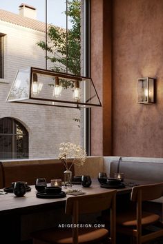 a dining room table with plates and cups on it next to a window that looks out onto the courtyard