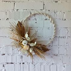 a white brick wall with some dried flowers on it