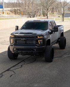 a black truck parked in a parking lot