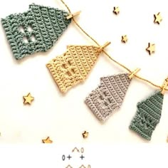 crocheted christmas stockings hanging on a string with gold stars around them and the words happy new year written in small letters