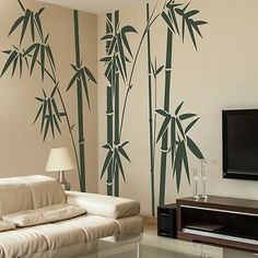 the living room is decorated in white and green with bamboo trees painted on the wall