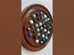 a wooden plate with marbles on it