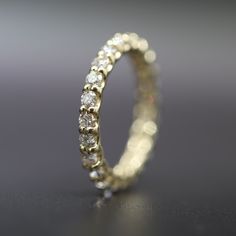 a diamond ring on a black surface