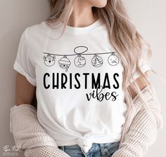 a woman wearing a t - shirt that says merry christmas