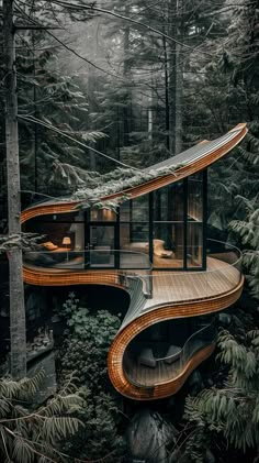 an unusual house in the woods surrounded by trees