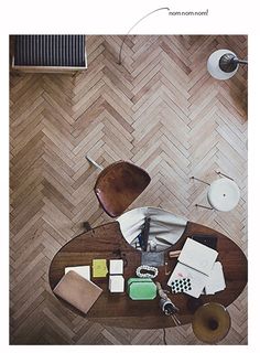 an overhead view of a living room with wood flooring and wooden furniture, including a coffee table