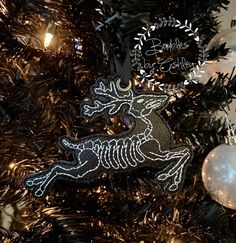 an ornament on a christmas tree with ornaments in the shape of a skeleton